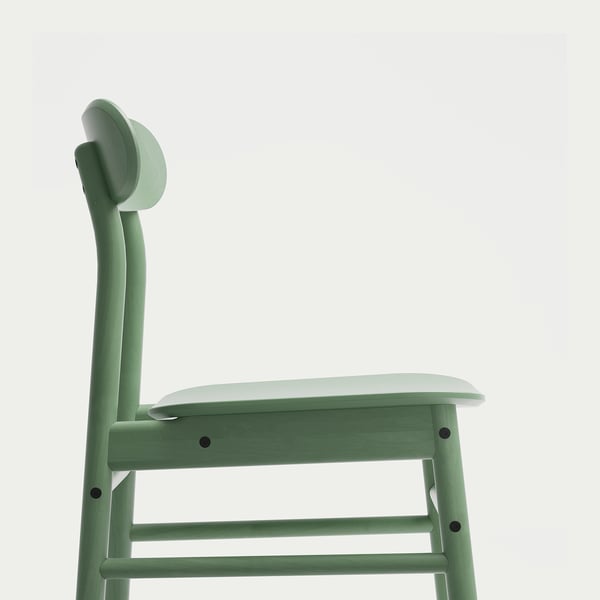 A green wooden chair with a curved backrest on a white background.