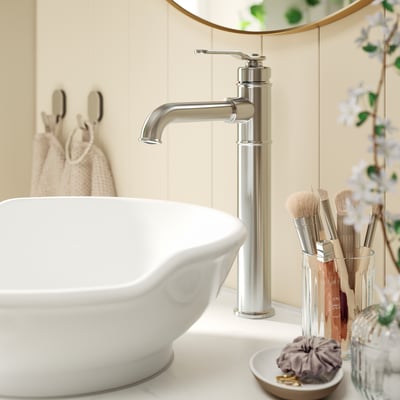 Modern white sink with chrome tap and towel hooks in minimalist design.