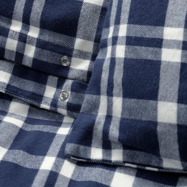 Close-up of a cosy blue and white chequered flannel fabric, showcasing its soft texture and detailed stitching.