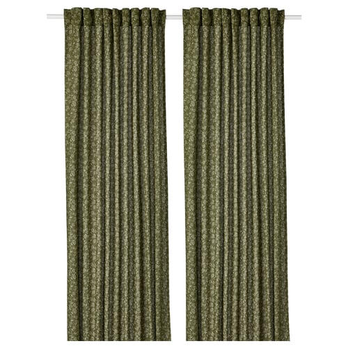 Green floral-patterned curtains with white accents, drawn to each side.