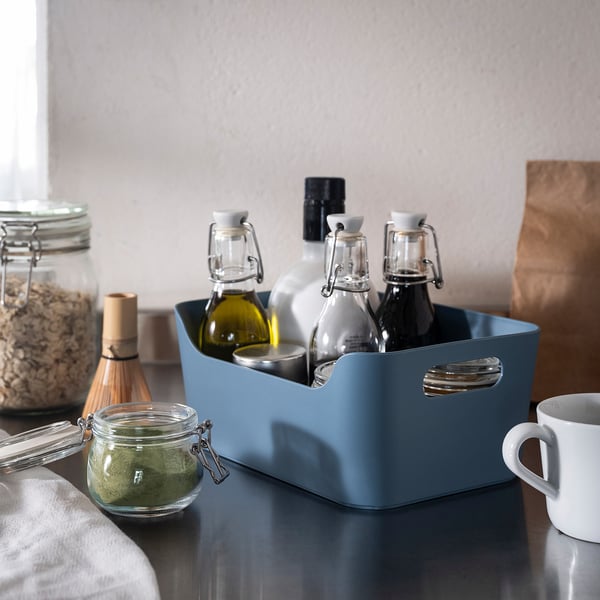 Blue recycled plastic storage box with handles on counter.