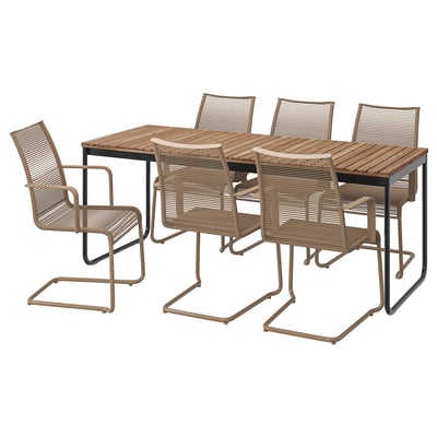 Brown patio set with wooden table and wicker chairs.