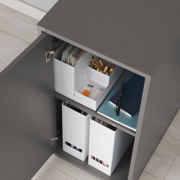 Wide desk cabinet with open drawers showing files, pencils, and a tablet. Part of ALEX series by IKEA.