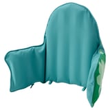 A turquoise ANTILOP baby highchair cushion with a green forest design on one side, made from recycled polyester.