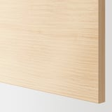 Close-up of a sleek, natural wood-textured surface, likely from a cabinet door or drawer front, showing subtle grain detail and smooth finish.