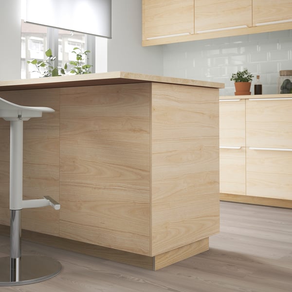 Light ash kitchen cabinets, minimalist design, tall, sleek, with plants & appliances.