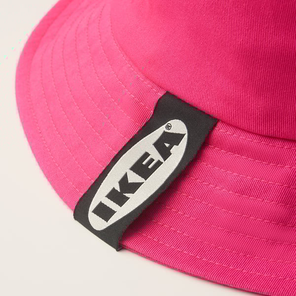 Bright pink baseball cap with black and white ikea logo on front.
