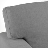 Close-up of plush, upholstered sofa cushion. High-quality fabric, soft and inviting.