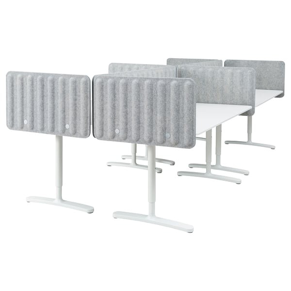 Six modern desks with acoustic screens, vertical grooves, white legs.