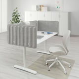 BEKANT office desk with white chair, gray screen, cable management, and wall storage.