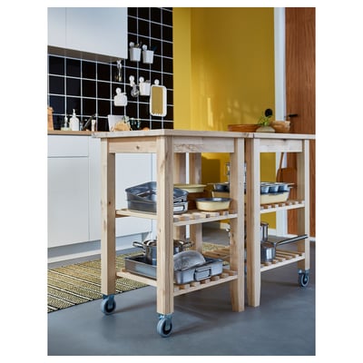 A BEKVÄM light birch wooden kitchen trolley with two shelves and wheels.