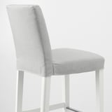 A modern bar stool with a grey cushioned seat and backrest, supported by sleek white metal legs.