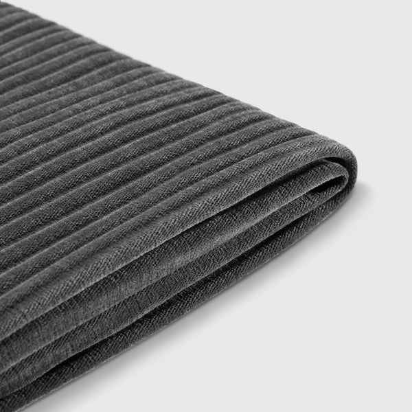 Displays a close-up of a black, ribbed, recycled polyester fabric, likely from a laundry basket.