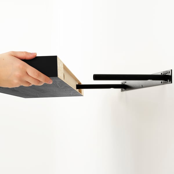 Hand placing BESTÅ wall shelf on bracket for modern storage