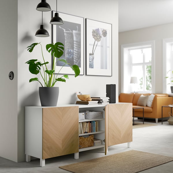 Modern living space with BESTÅ storage; adjustable shelves, soft-closing doors, and plant decoration.