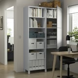 Modern BESTÅ storage with adjustable shelves, holding books, boxes, and decor.