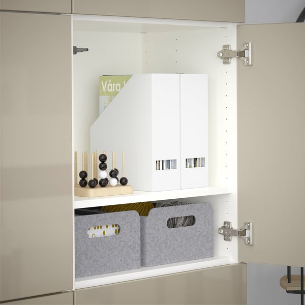 Open storage cabinet with adjustable shelves and dividers, showing organizer bins and decorative items.
