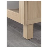 Modern wooden sideboard with light oak finish, standing on a patterned wooden floor, showcasing its sturdy build and craftsmanship.