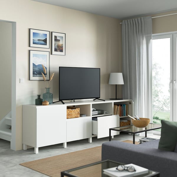 Modern living room with BESTÅ tv unit, featuring adjustable shelves, cable management, soft-close drawers, and a flat-screen tv.