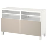 A white BESTÅ tv bench with beige doors. It includes four adjustable shelves for storage, providing a modern and functional design.