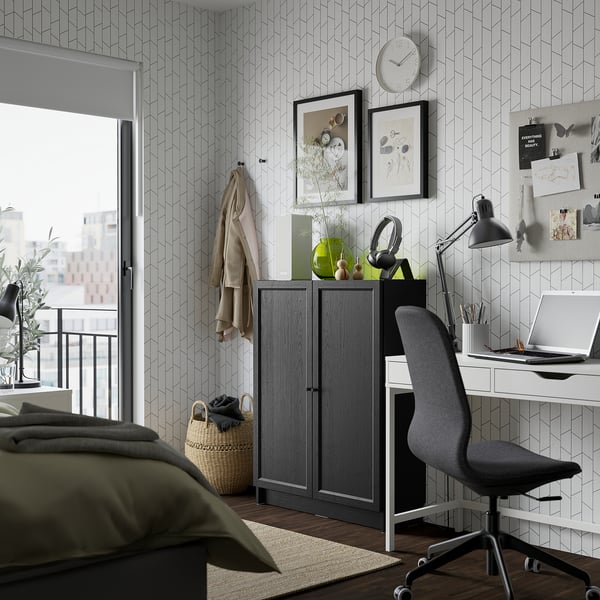 Modern bedroom with dark gray BILLY bookcase, olive-green bed, desk, and natural light.