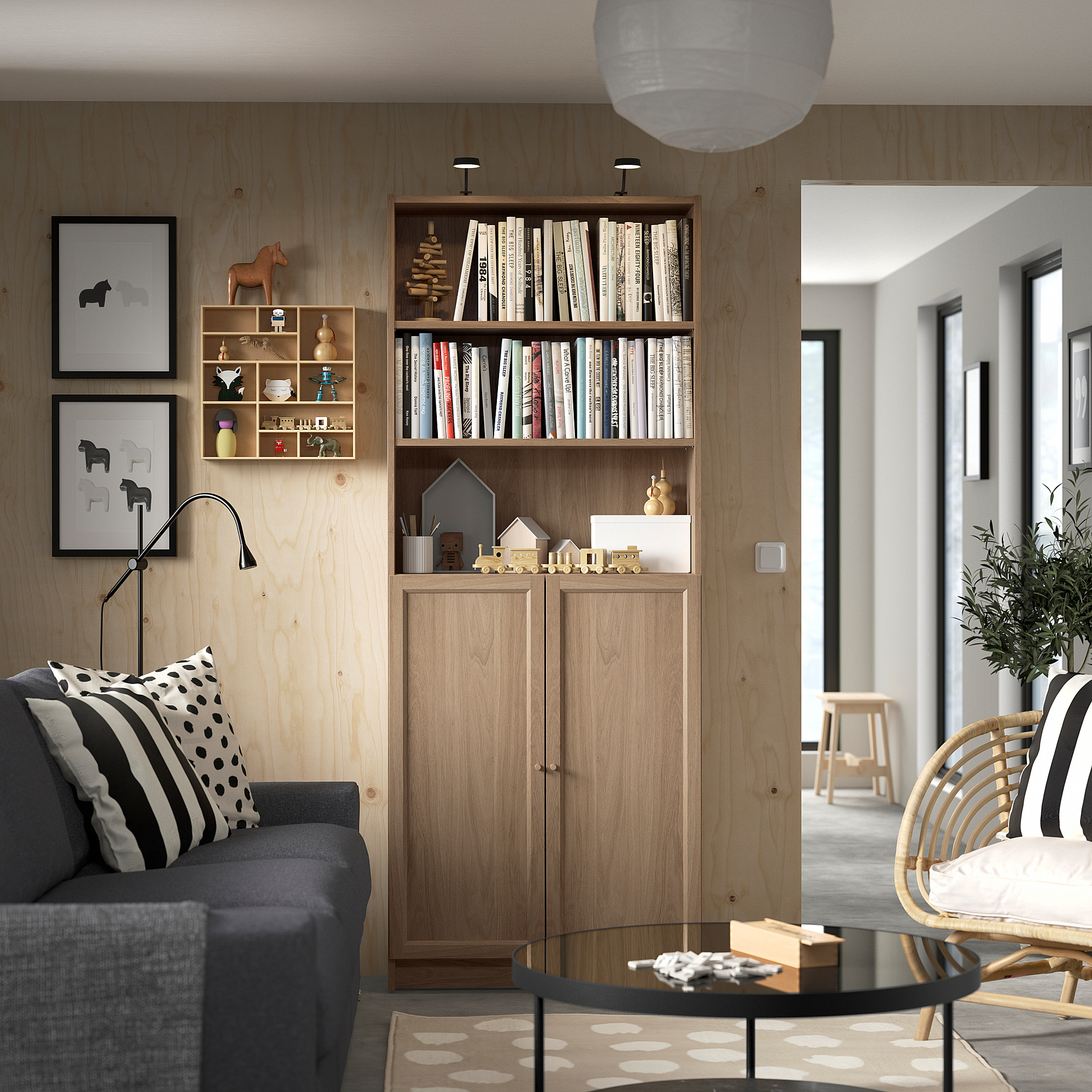 Modern living room with BILLY bookcase, sofa, wicker chair, and adjustable floor lamp.