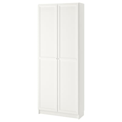 A white BILLY bookcase with doors. Its made of particleboard and has a simple, rectangular design with adjustable shelves.