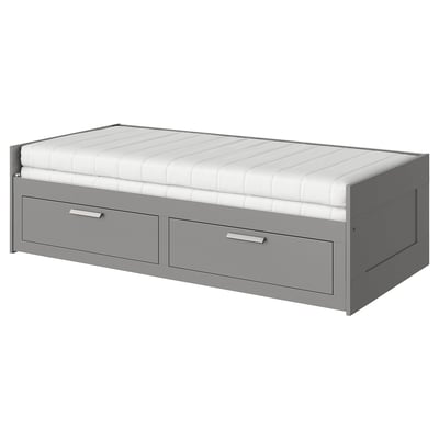 Gray space-saving BRIMNES day-bed with drawers and white mattress.