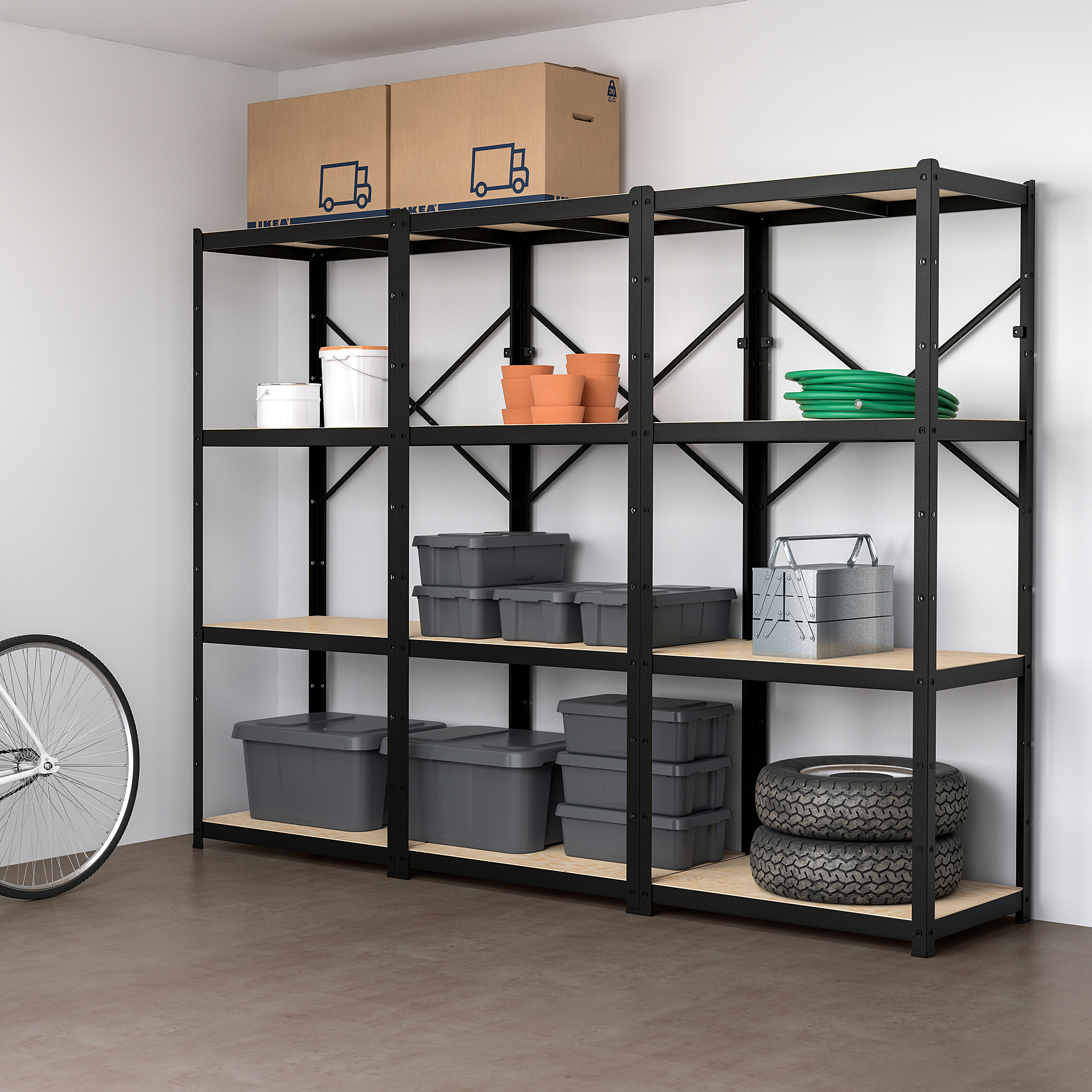 BROR black metal storage rack held large items like boxes, wheels, and bins. Tall, sturdy, four-tiered shelves hold heavy loads in garage or home.