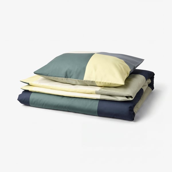 BRUNKRISSLA duvet cover in teal, cream, navy, folded with matching pillowcase. Chequered pattern, cotton-viscose blend.