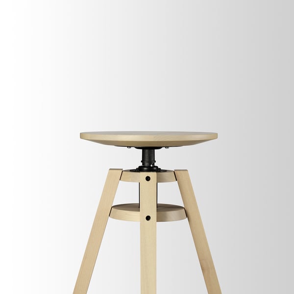 Adjustable wooden stool with round seat, three angled legs, and a footrest. Ideal for various heights.