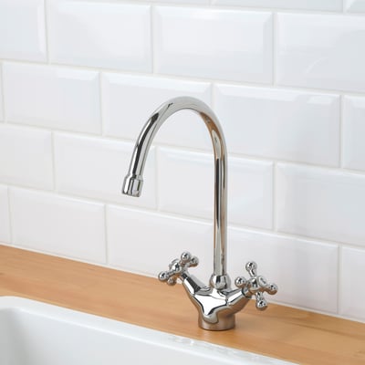 This image a chrome EDSVIK kitchen tap with a high, curved spout and traditional cross handles.