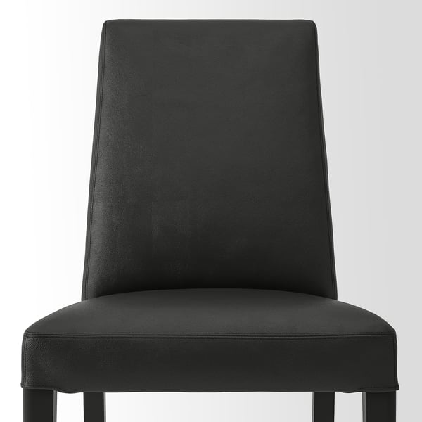 Modern black leather chair. Upholstered back and seat, solid legs. Elegant and sturdy design.