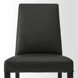 Modern black leather chair. Upholstered back and seat, solid legs. Elegant and sturdy design.