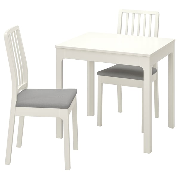 White wooden dining set with extendable table and two cushioned chairs.