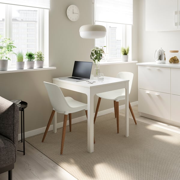 Minimalist white desk & chairs. Small sized, fits under window, bright & clean home office setup.