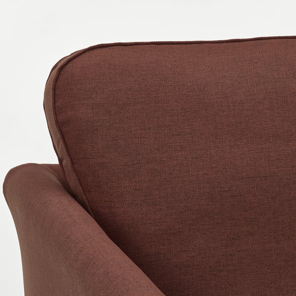 Close-up of brown EKHOLMA sofas armrest, showcasing soft kilanda fabric and cushioned comfort.