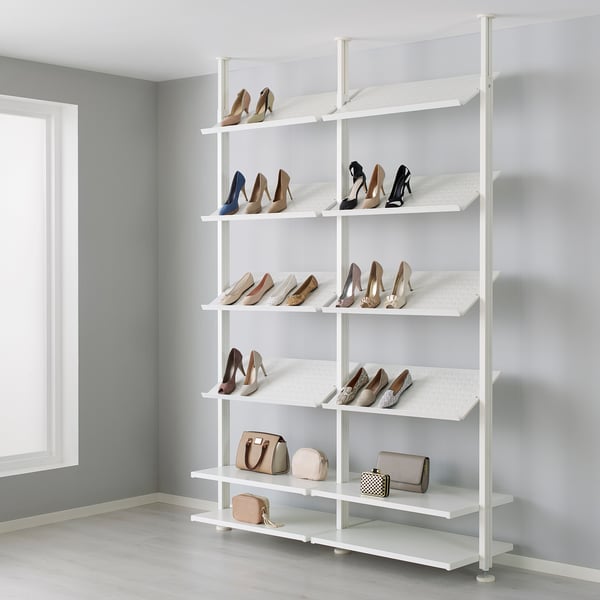 White shoe rack with multiple shelves holding various heels and purses. Shelves are adjustable and floor-to-ceiling height.