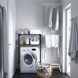 Laundry room with ENHET storage, laundry items, and wicker basket.