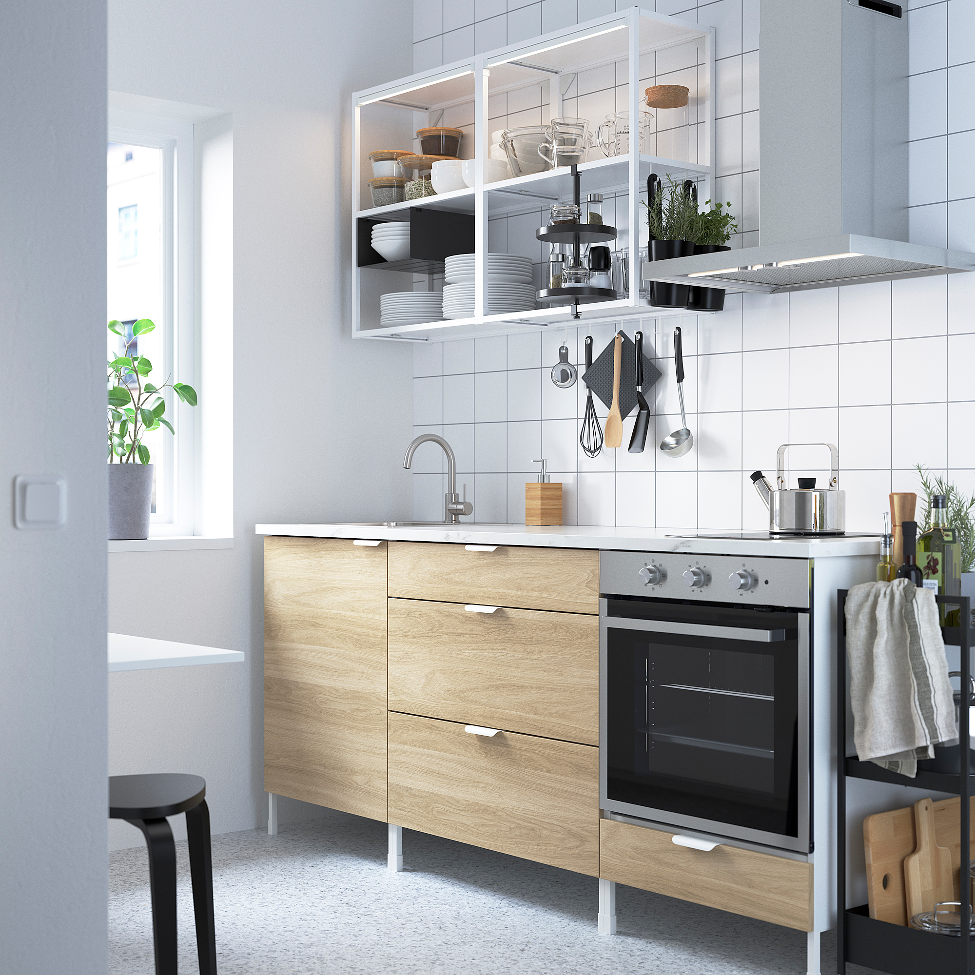 Modern kitchen with light wood cabinets, stainless steel appliances, and white backsplash. Open shelves near oven and sink.