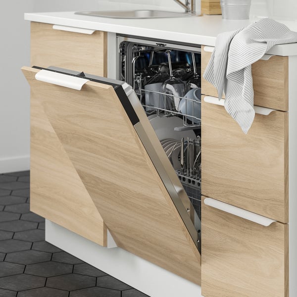 Open dishwasher in modern kitchen with wooden cabinets and tiled floor, displaying clean dishes.