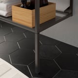 Black metal bathroom shelf with wooden boxes. Adjustable legs compensate floor irregularities, shown in image.