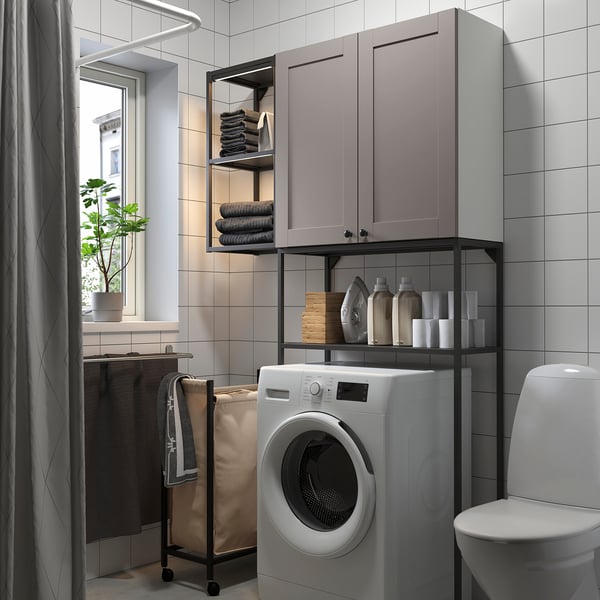 Modern grey bathroom with ENHET storage, laundry, washing machine, and organized toiletries.