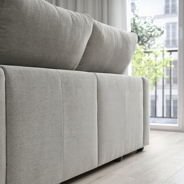 Light gray ESKILSTUNA sofa with high back, plush cushions, modern minimalist design, fits large rooms.