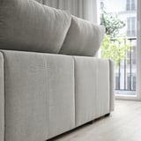 Light gray ESKILSTUNA sofa with high back, plush cushions, modern minimalist design, fits large rooms.