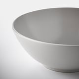 White glossy bowl on light surface.