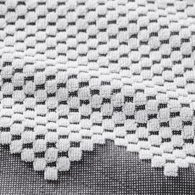 A FJÄLLSTARR towel in blue & white. The pattern is bohemian with fringe. Its woven from cotton and hangs on a hook.