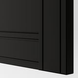 Closeup of matte black FLISBERGET cabinet door, showing smooth finish and subtle grooves.