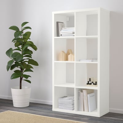 FLYSTA shelf with books, decor, and plant.