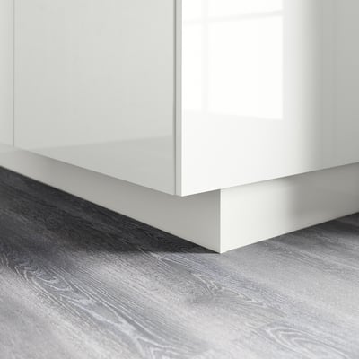 Image a glossy white kitchen plinth. It covers the gap between the floor and base cabinets, providing a clean look and easy cleaning.